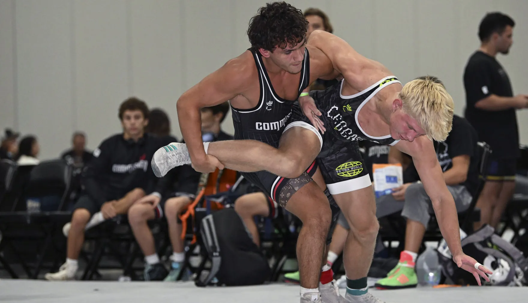 Two wrestlers in a scramble in custom Compound singlets